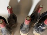 several bottles of wine are lined up in a row on a table