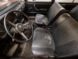 dashboard of an old car with black leather seats and a steering wheel