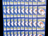 several packs of pokemon trading cards are stacked on top of each other