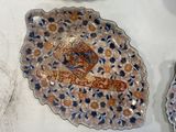 three plates and a bowl are sitting on a table