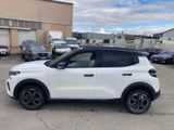a white suv parked in a parking lot next to a building