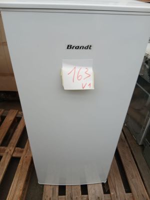a white refrigerator sitting on a pallet with a note pinned to it