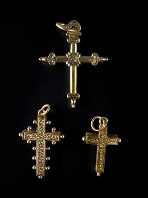 three gold crosses on a black background