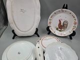 several plates and bowls are sitting on a table with a gray background