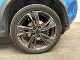 a close up of a tire on a blue car