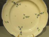 une assiette jaune ornée de fleurs violettes