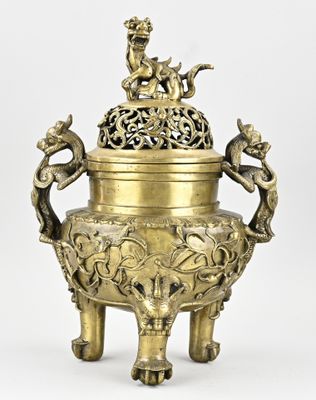an image of a brass vase with two birds on top of it