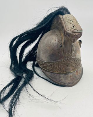 a helmet with long black hair on a white surface
