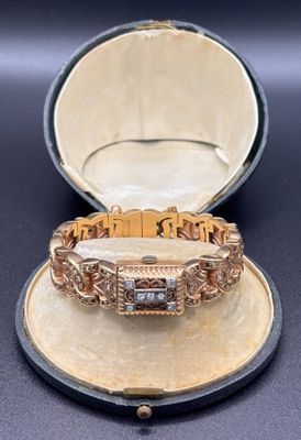 an image of a gold and diamond bracelet in a case