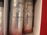 three cans of soda sitting in a box on a shelf