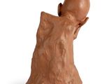 a clay figurine of a man with a head in his hands