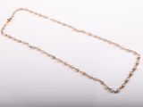 a close up of a gold chain with a diamond on it