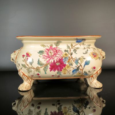 a vase with flowers on it sitting on a table