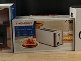 three boxes on the table with a coffee maker and a toaster