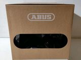 a cardboard box with a pair of black shoes inside of it