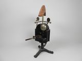 an old camera on a tripod stand on a white background
