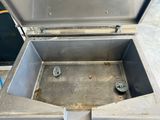 a metal box with a lid that is open on the floor
