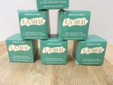 four boxes of soap sitting on top of a wooden table