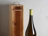 a bottle of wine sitting next to a wooden box