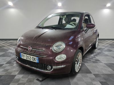 a small car that is sitting on a checkered floor