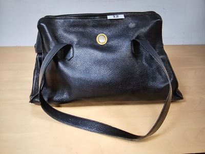a black purse sitting on top of a wooden table