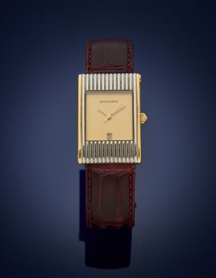 une image représentant une montre dorée et marron sur fond bleu