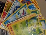 a lot of pokemon cards sitting on a table
