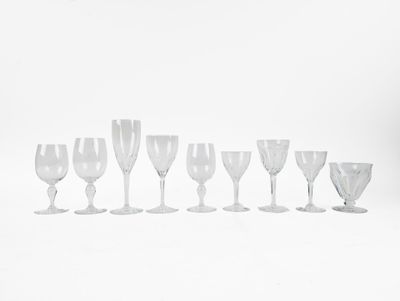 nine wine glasses lined up in a row on a white surface