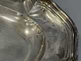 a silver tray that has a handle on it