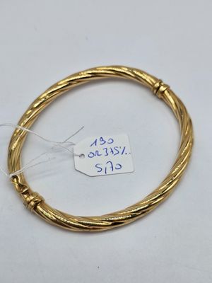 a close up of a gold bracelet with a price tag on it