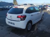 the rear of a white citrole parked in a parking lot