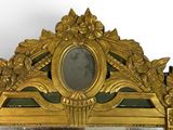 a mirror with a gold frame and a mirror with a picture on it