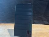 an image of a cell phone sitting on top of a wooden table