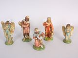 several figurines of different sizes and colors are displayed on a white surface