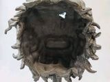 a sculpture of a face made out of a piece of wood