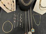 various necklaces and bracelets displayed on display on a table