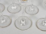 six wine glasses sitting on a table with a cookie on top of them
