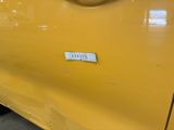 a yellow car with a sticker on the side of it