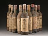 six bottles of wine are lined up in a row on a table