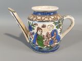 a blue and white tea pot with a spoon in it