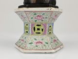 a statue of a man sitting on top of a vase