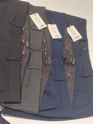 three men ' s dress pants are lined up on a white surface