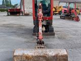 a small bulldozer that is parked in a parking lot
