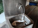 a metal sink with a faucet in the middle of it