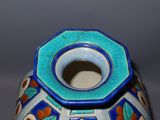 a blue and white vase with a flower design on it