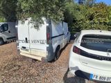 two white vans parked in a parking lot next to each other
