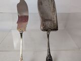 two spoons and a fork sitting on a table