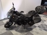 a picture of a black motorcycle parked on a checkered floor