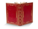 un livre rouge ouvert sur une surface blanche