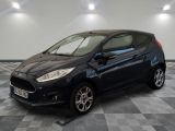 the black ford fiesta is parked on a checkered tile floor